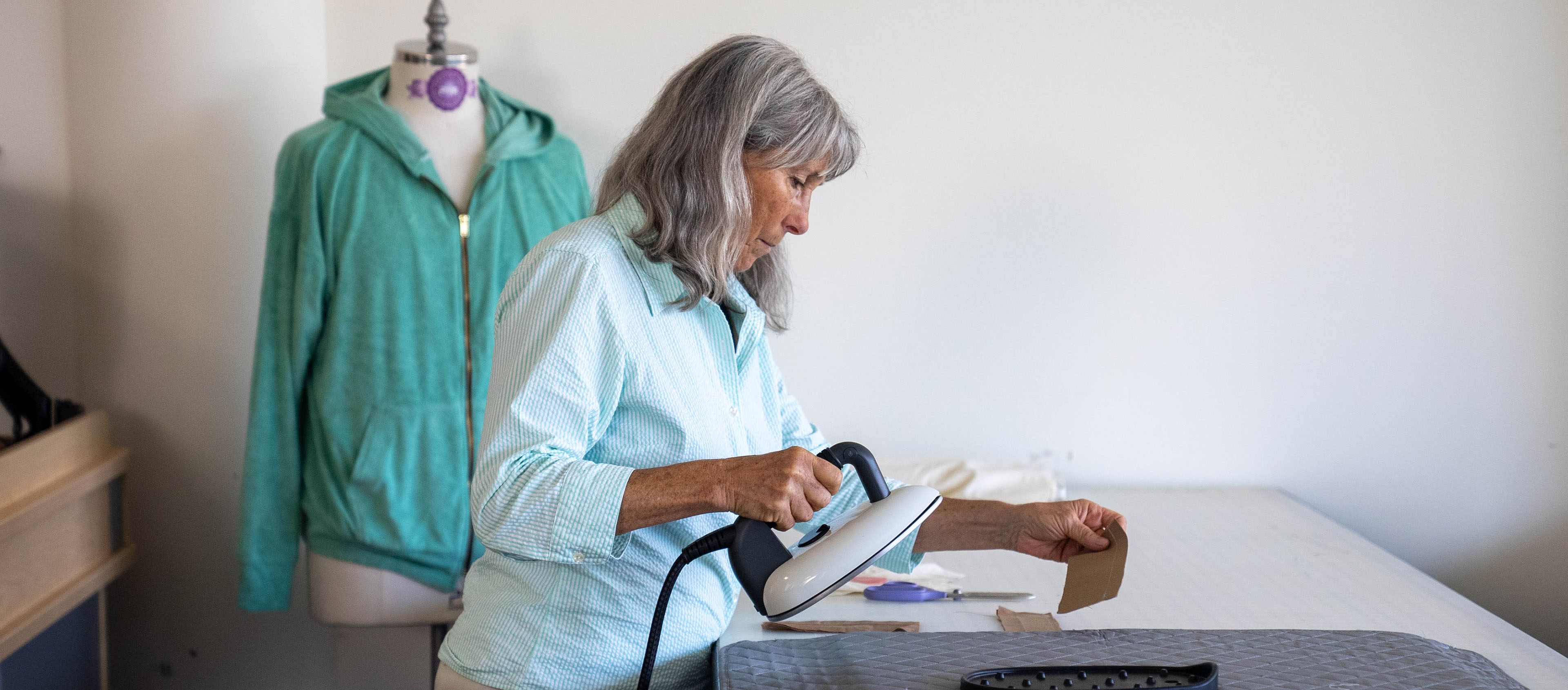 Female clothing and textiles student ironing