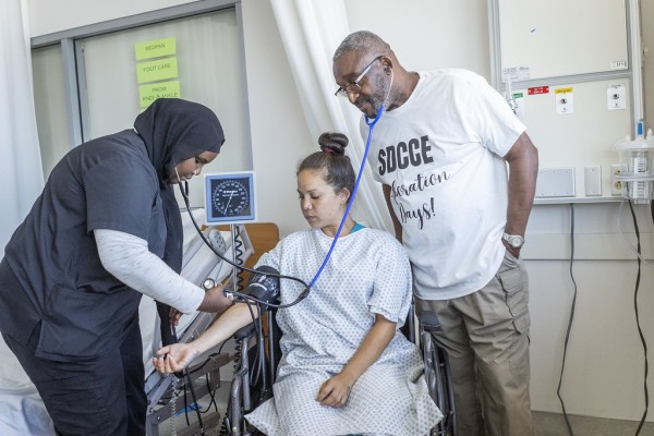 Professor Kenny Parker (far right) leads students through CNA curriculum